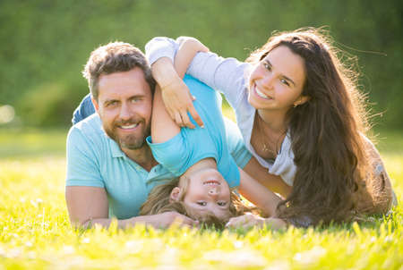 friendly family having fun in summer. happy parents with kid boy. mom dad and son love relaxの写真素材