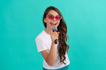 Music is what I am. Happy child sing song. Karaoke and live music. Girl singer hold microphoneの写真素材