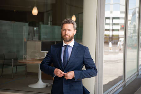 serious bearded man boss in businesslike suit outside the office, business executiveの写真素材