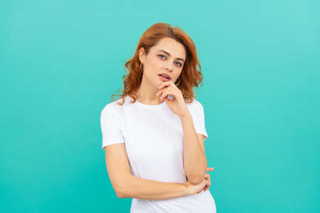 sexy pretty look of young girl. portrait of redhead lady on blue background. skincare conceptの写真素材