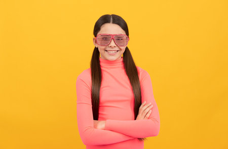 smiling kid in glamour party eyeglasses on yellow background, fancy lookの写真素材