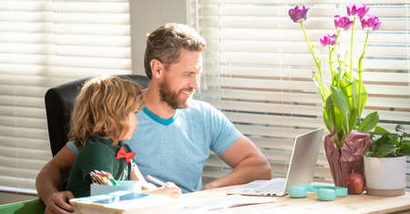 happy father helping his school kid study with writing and laptop, schoolの写真素材