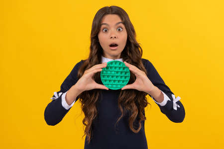 shocked teen girl hold pop it or popit silicone sensory fidget toy, popitの写真素材