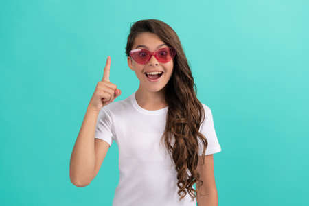 happy kid long curly hair in sunglasses casual style inspired with idea on blue background, ideaの写真素材