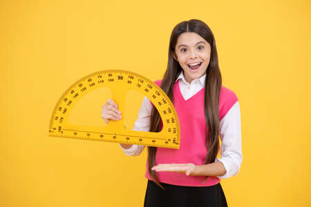 try this. child with protractor. angle degree measurement surprised teen girl hold ruler.の写真素材
