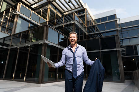 successful happy businessman man celebrating business success outside the office, excitementの写真素材