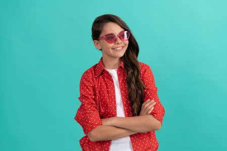 cheerful kid with curly hair in sunglasses. beauty and fashion. female fashion model.