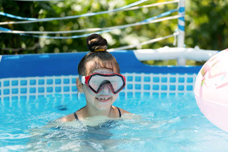 Best pool ever. Happy child swim in outdoor pool. Summer vacation. Leisure and recreation