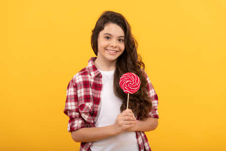sweet tooth. yummy. happy girl hold lollipop. lollipop child. hipster kid hold lollypop.の写真素材