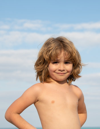 Fun in the sun. Portrait of shirtless boy. Happy boy child sky background. Summertime. Summerの写真素材