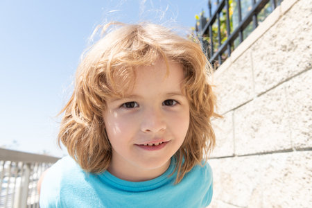 Portrait of happy boy child smiling summer outdoors, faceの写真素材