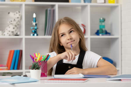 schoolgirl writing. school girl with notebook. back to school. teen girl ready to study.の写真素材
