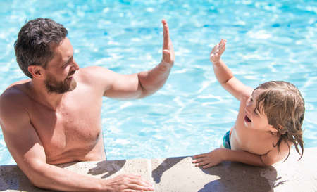 happy family of father and child having fun in summer swimming pool, summerの写真素材
