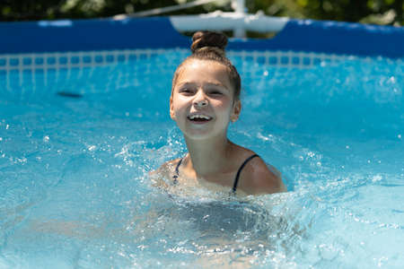 My life is cool in the pool. Happy girl swim in outdoor pool. Swimming bath. Summer vacationの写真素材