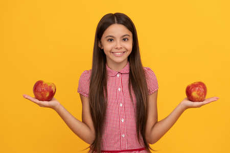 diet and kid beauty. dental care. lunch break. detox. happy tween girl with red apple fruit.の写真素材
