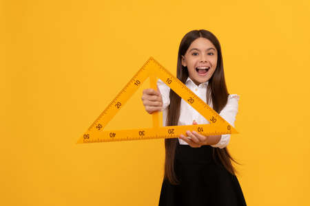measuring and sizing. education for child. mathematics. happy tween girl hold triangle.の写真素材