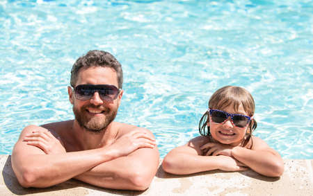 summer holidays weekend at family day. dad and child having fun at pool party.の写真素材