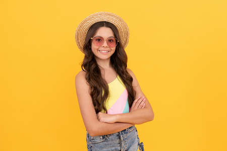 childhood happiness. summer party look. happy funny kid in eyeglasses and straw hat.の写真素材