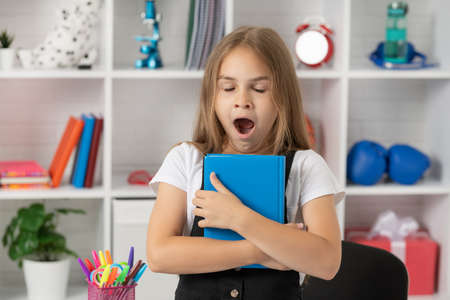 lesson for child holding copybook. schoolgirl hold notebook. back to school. childhood education.の写真素材