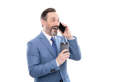 communication. businessman speak on smartphone and drink tea.の写真素材
