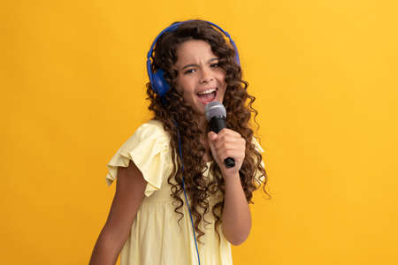 new technology. childhood development. child singer sing karaoke in microphone.の写真素材