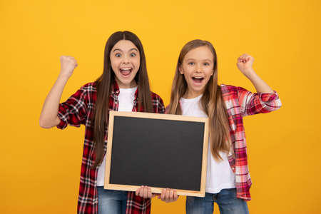 happy children in casual checkered hold school blackboard for copy space, successの写真素材