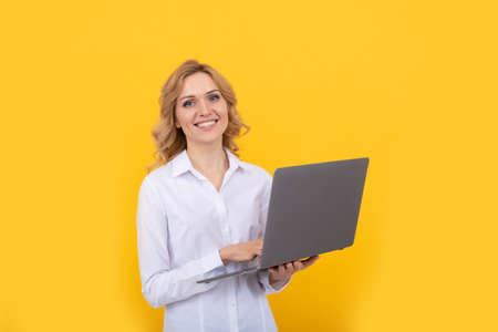 cheerful freelance woman post blog online. copy space. businesswoman use laptopの写真素材