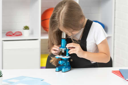 future scientist kid looking through scope. harness scientific method. science and childhood.の写真素材