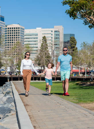 family day. friendship. father mother and child walking in park. friendly family having funの写真素材