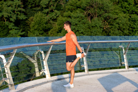 Stretching keeps the muscles flexible. Sportsman grab ankle with hand. Static stretching
