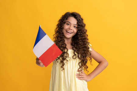 happy child long curly hair hold french flag, franceの写真素材