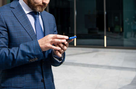 cropped man boss check email. business negotiation. adult ceo texting on cellphone.の写真素材