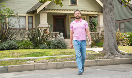 full length. real estate agent sell property. realtor in suburb neighborhood. man buying houseの写真素材
