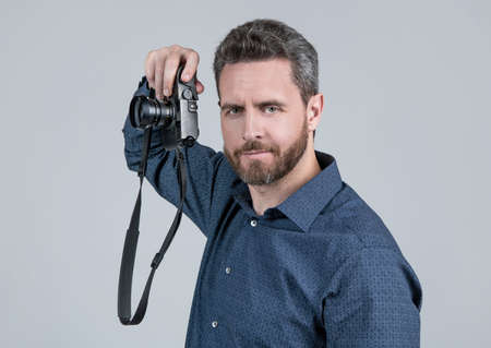Photography is my hobby. Unshaven man hold photo camera. Hobby conceptの写真素材