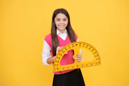 Educational concept. measurement. happy teenage girl with protractor. back to school.