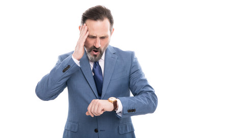 tired mature entrepreneur in suit check time on watch isolated on white, overworkingの写真素材