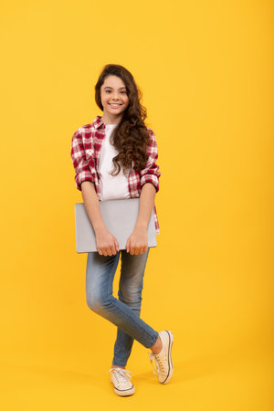 Distance education with elearning. Happy tween girl with laptop. Distance educationの写真素材