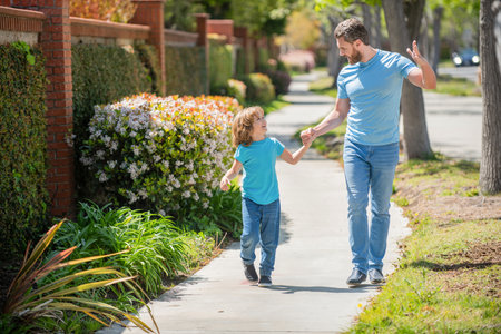 happy dad with child walk together in park, summertimeの写真素材