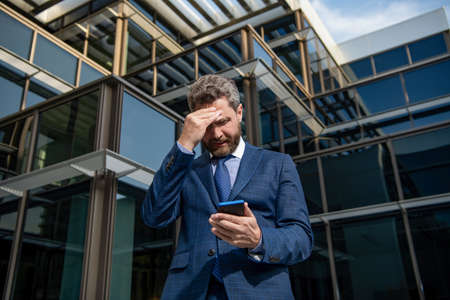 man boss has conversation. business negotiation. having problem. adult ceo with cellphone.の写真素材