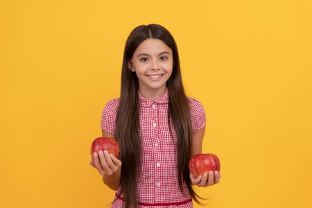 cheerful teen girl hold healthy apple fruit with vitamin, dietの写真素材