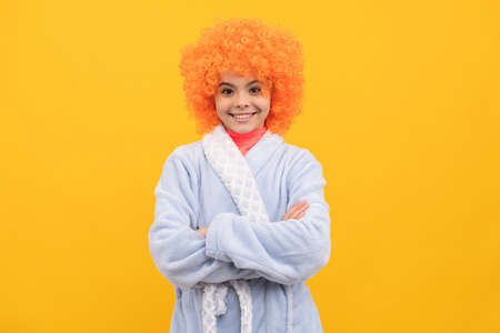 happy kid in fancy orange wig hair wear home bathrobe, fancy lookの写真素材