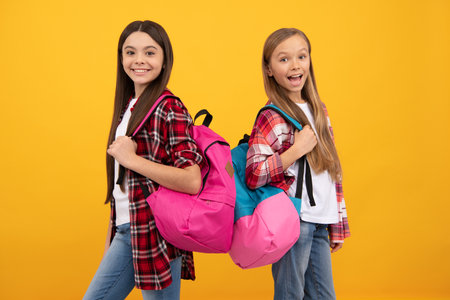 happy teen girls carry backpack. back to school. knowledge day. concept of education.の写真素材