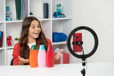 amazed child long curly hair making video review of shampoo beauty blog, hair cosmeticの写真素材