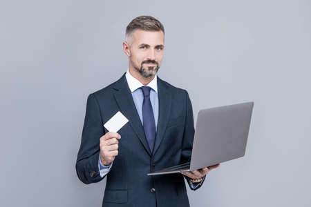 network administrator hold laptop. man pay in online banking. online money.の写真素材