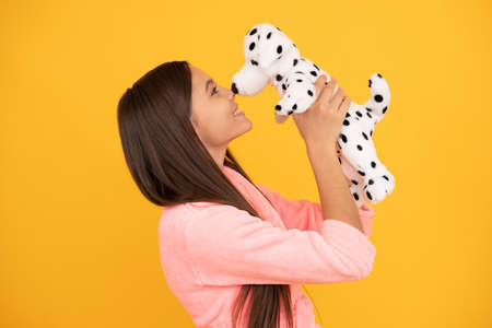 happy teen girl in home terry bathrobe with toy, loveの写真素材
