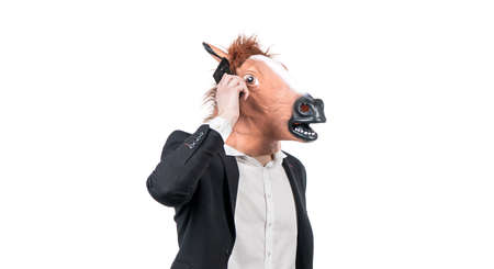 Hardworking man in horse head talk on mobile phone isolated on white, business communicationの写真素材