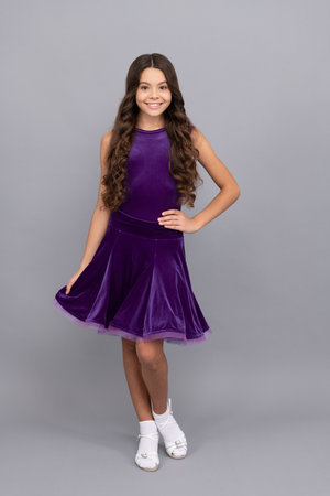 child in purple dance dress. dancing school. full length of kid with frizz hair.の写真素材