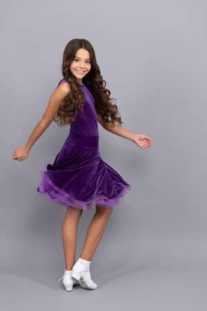 dancewear fashion clothes. happy teen girl junior ballroom dancer. child in purple dance dress.の写真素材