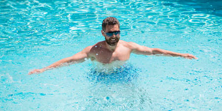 cheerful man in swimming pool. Pool party. Summer mood concept. Summertime vacation.の写真素材