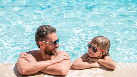 dad and child having fun at pool party. childhood and parenting. father and sonの写真素材